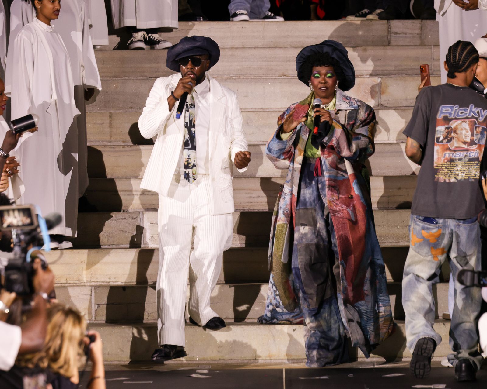 Image may contain Wyclef Jean Lauryn Hill Adult Person Clothing Dress Coat Formal Wear Wedding Face and Head