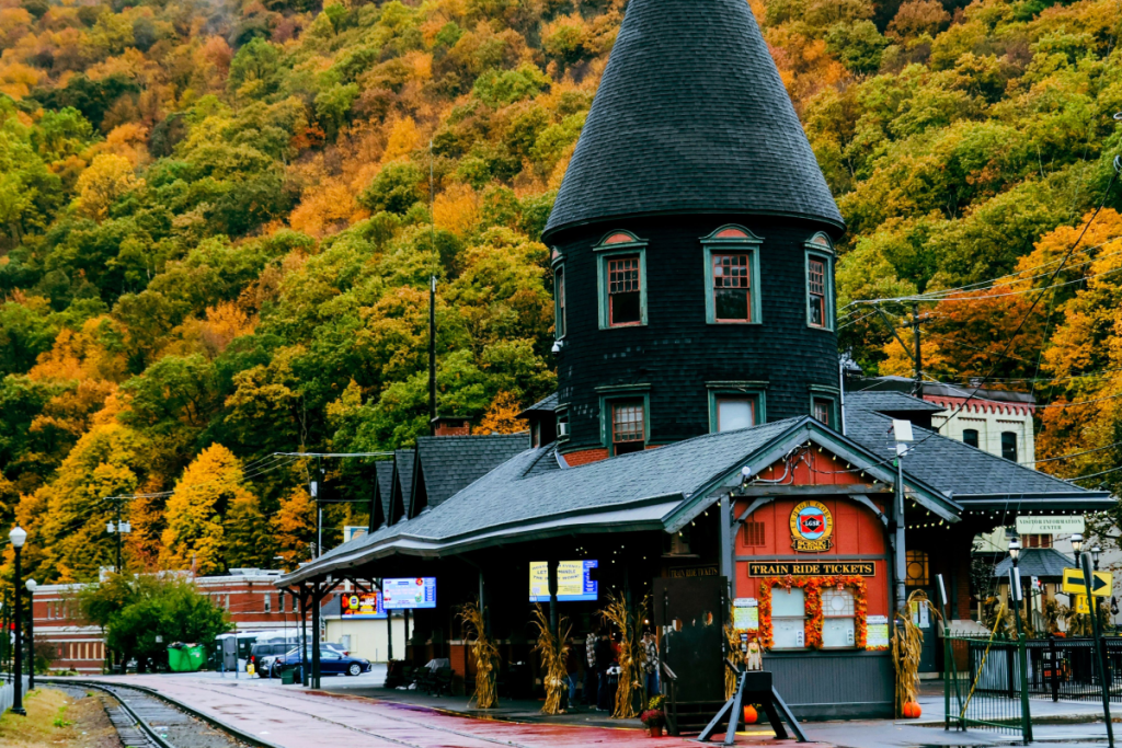 Charming vintage train station surrounded by vibrant autumn foliage, showcasing the beauty of the season in Jim Thorpe, Pennsylvania