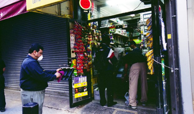 Workers tidy up a bodega in Lower Manhattan amid cleanup efforts on Sept. 17, 2001. (Heidi Schumann for New York Daily News)