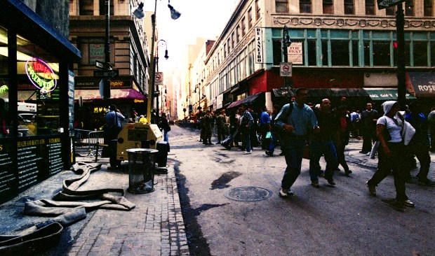 Residents and workers are pictured on a partially-blocked John. St. in Lower Manhattan amid cleanup efforts on Sept. 17, 2001. (Heidi Schumann for New York Daily News)