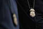The badges of Immigration and Customs Enforcement (ICE) agents are seen as they patrol the halls of immigration court at the Ted Weiss Federal Building in New York City.