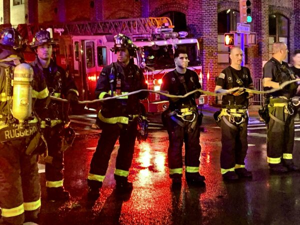 Following the response, firefighters formed a human chain to guide the hose back into the truck. Photo: Mary Frost/Brooklyn Eagle