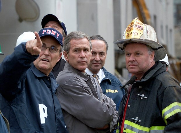 President George W. Bush (C) surveys the damage at the site of the World Trade Center with New York Mayor Giuliani (L) and a New York City Fire Department Official on Sept. 14, 2001, in New York. (PAUL J. RICHARDS/AFP via Getty Images)