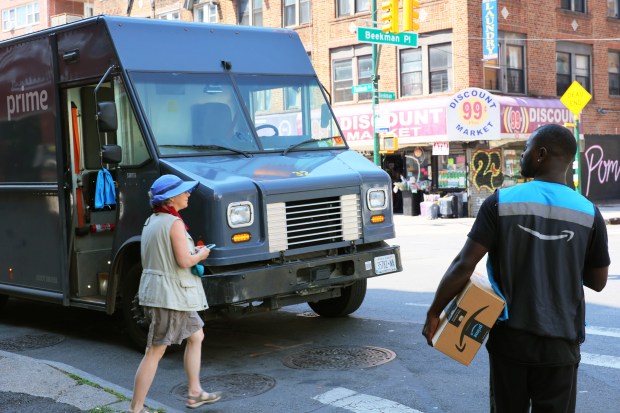 NEW YORK, NEW YORK - JULY 12: An Amazon worker holds a package for delivery on Flatbush Avenue on July 12, 2022 in the Flatbush neighborhood of Brooklyn borough in New York City. Amazon is holding Amazon Prime Day in more than 20 countries, offering exclusive discounts on thousands of products, from July 12-13. The two-day sale began on 2015 as a celebration of the retailer's 20th anniversary. (Photo by Michael M. Santiago/Getty Images)