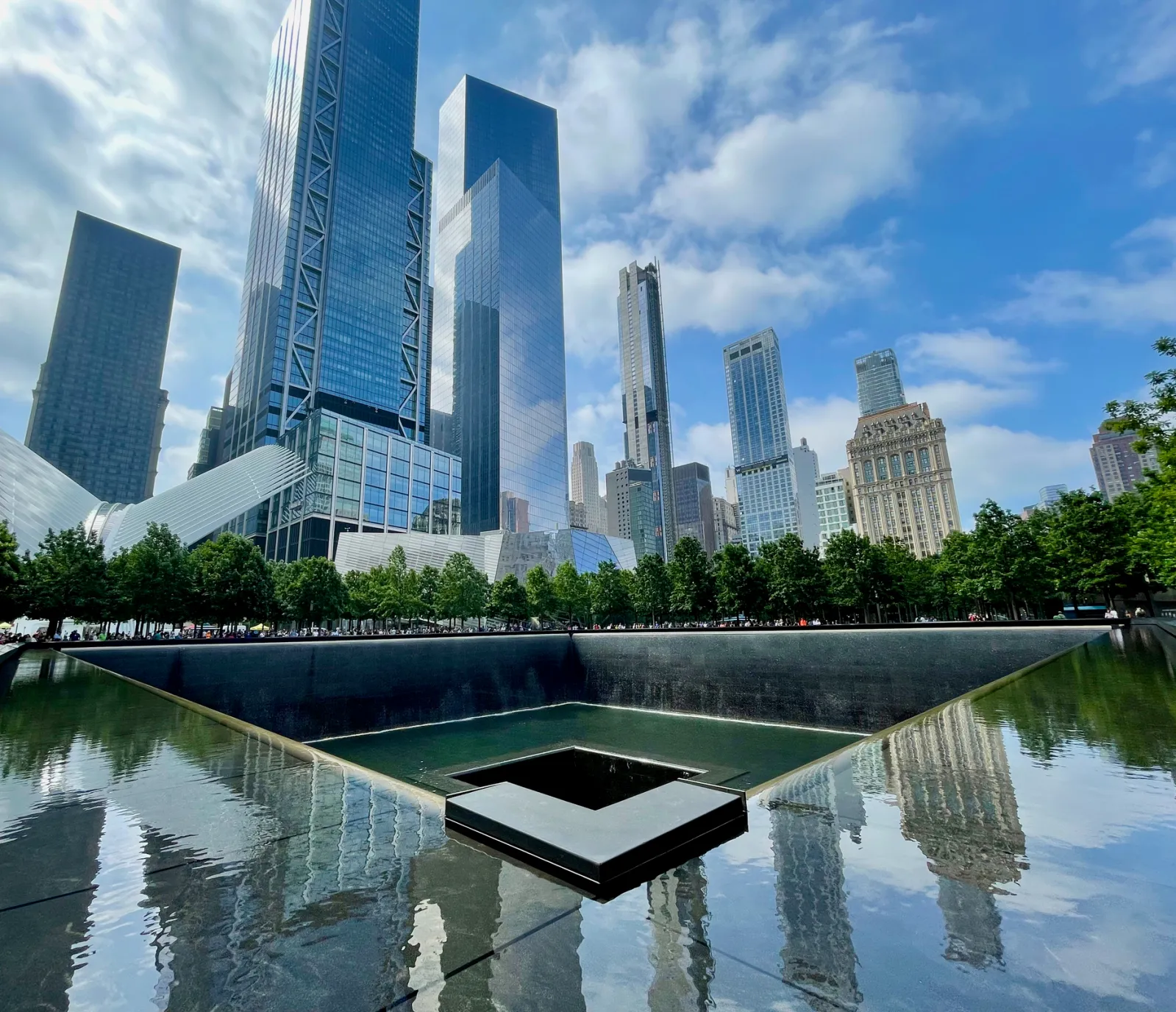 Skyscrapers overlooking the 9/11 memorial site showing a hole where the Twin Towers were previously destroyed.