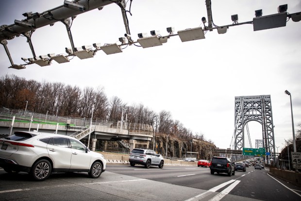 Cars pass under E-ZPass readers and license plate-scanning cameras on the George Washington Bridge as congestion pricing takes effect in New York City on January 5, 2024. On Sunday New York is reviving a controversial scheme to charge drivers entering parts of the city, a first in the United States, putting local authorities on a collision course with President-elect Donald Trump. (Photo by KENA BETANCUR / AFP) (Photo by KENA BETANCUR/AFP via Getty Images)