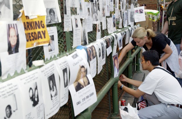Friends and family of missing people post signs with photos and descriptions to help locate them outside the armory on Lexington Ave. in New York City on Sept. 13, 2001, after the attacks on the World Trade Center. (Gabe Palacio/Getty Images)