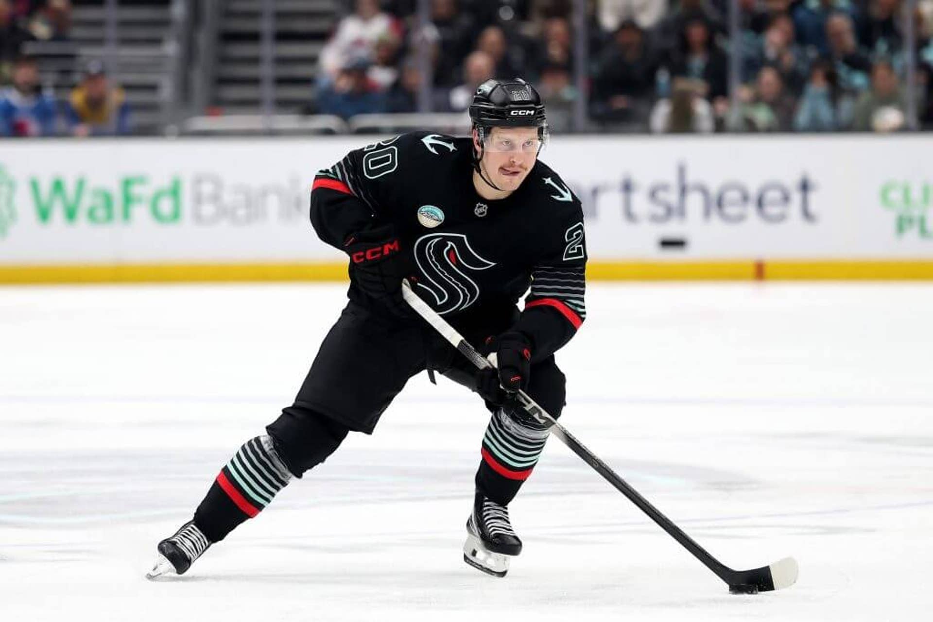 Eeli Tolvanen skates with the puck during a Seattle Kraken game.