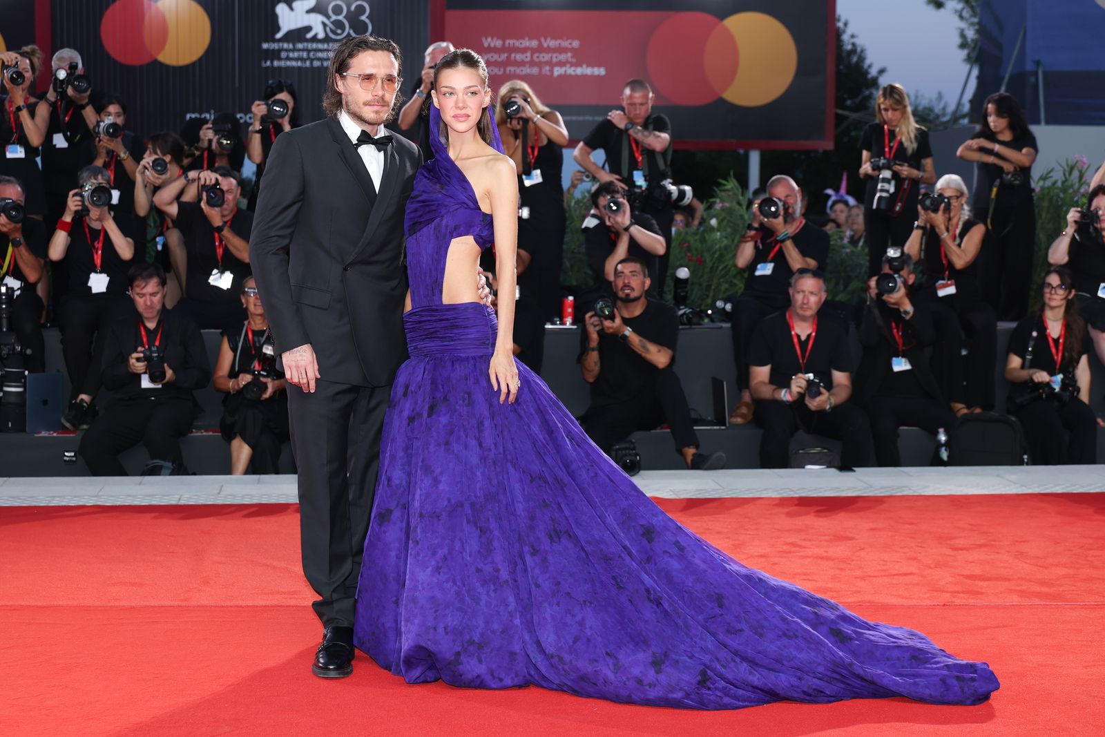 Image may contain Brooklyn Beckham Nicola Peltz Tom Costello Fashion Adult Person Wedding Face Head and Clothing