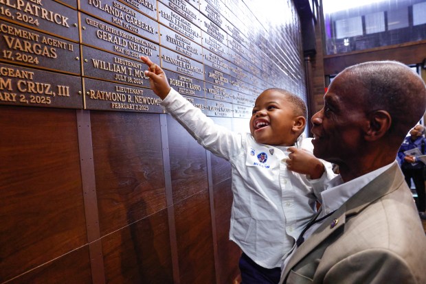 Family members of first responders stand by the new 9/11 Memorial Wall at One Police Plaza in New York, on Sept. 9, 2026. (Photo by kena betancur / AFP via Getty Images)