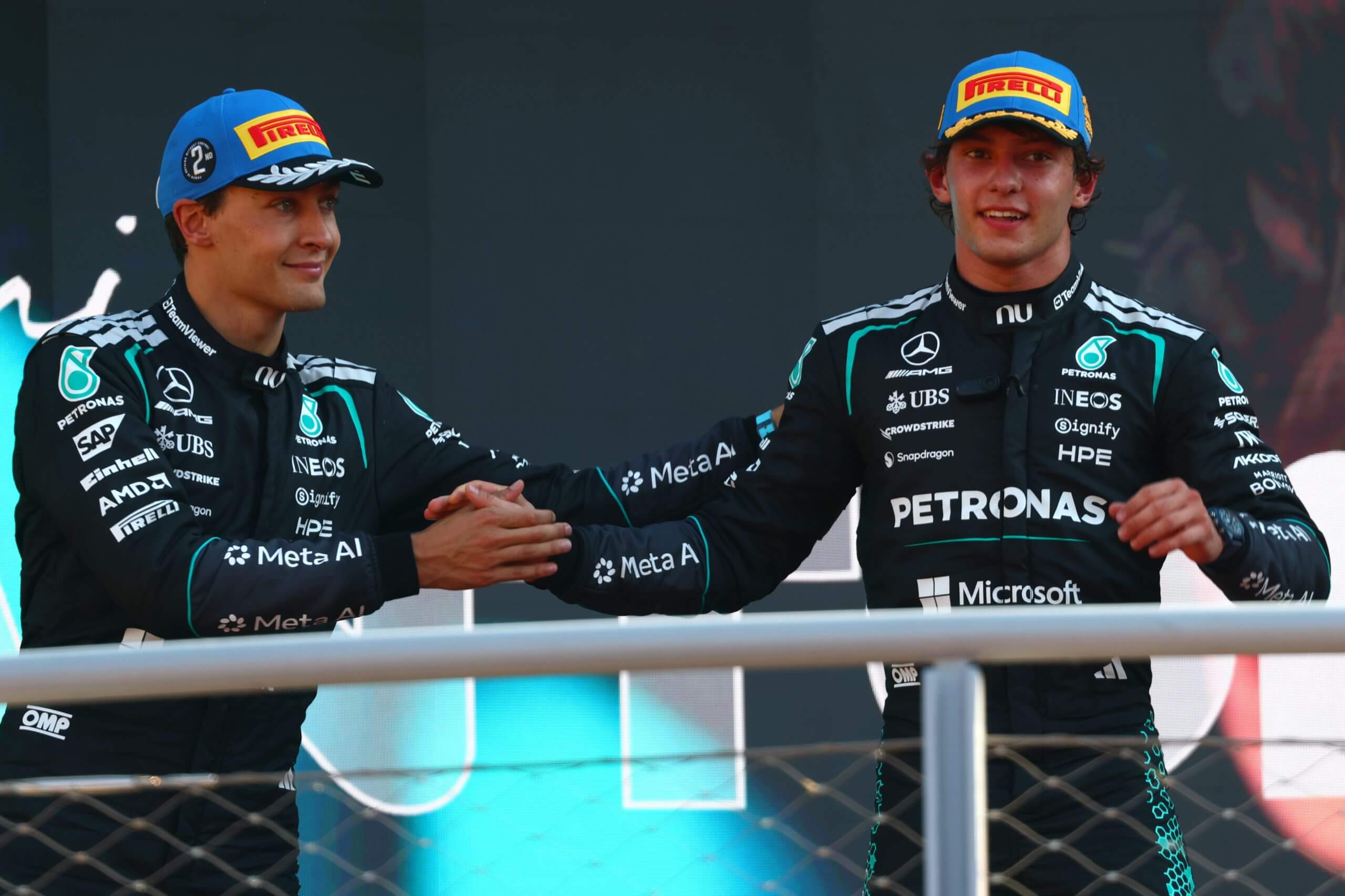 Kimi Antonelli is congratulated on the podium by his teammate George Russell