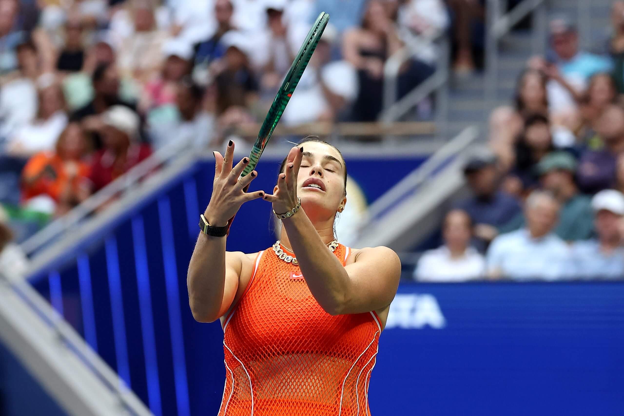 Aryna Sabalenka throws her racket in the air in annoyance.