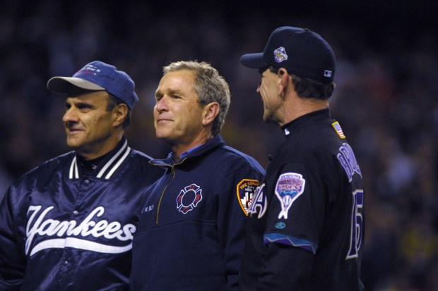President George W. Bush talks with managers Joe Torre #6 of the New York Yankees and Bob Brenly #15 of the Arizona Diamondbacks before game 3 of the World Series at Yankee Stadium in New York.