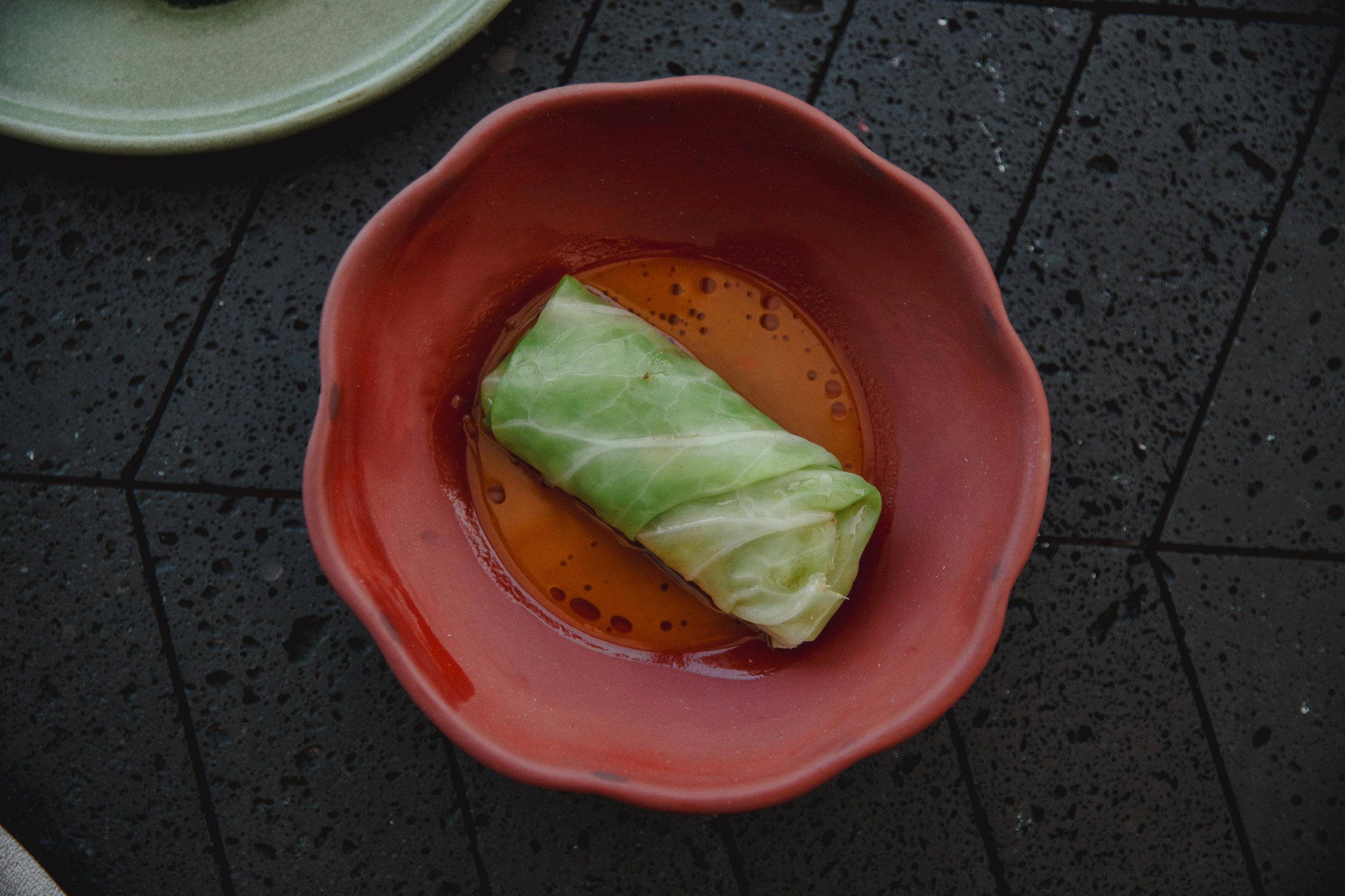 A green-wrapped roll on a plate.