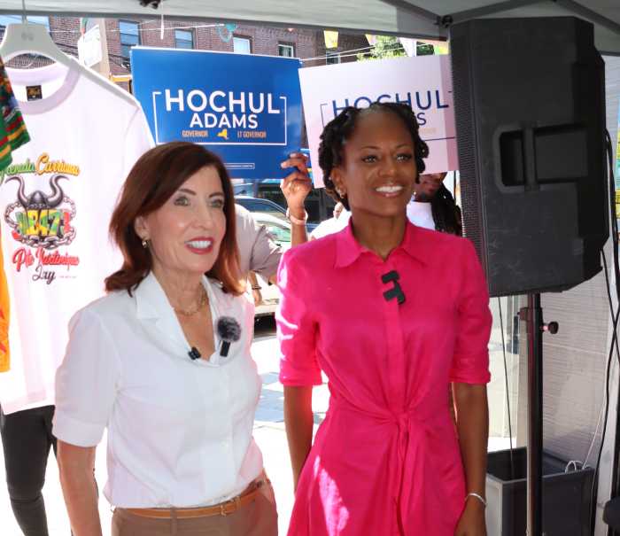 Gov. Kathy Hochul, left, with Assembly Member Monique Chandler-Waterman during a press conference outside R&R West Indian Cuisine on Church Avenue in Brooklyn.