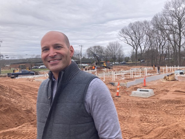 Josh Levy of Vessel Technologies at the site of the Cheshire apartment building under construction in the late winter of 2024. Two and a half years later, it is essentially complete but vacant. (Don Stacom/The Hartford Courant)