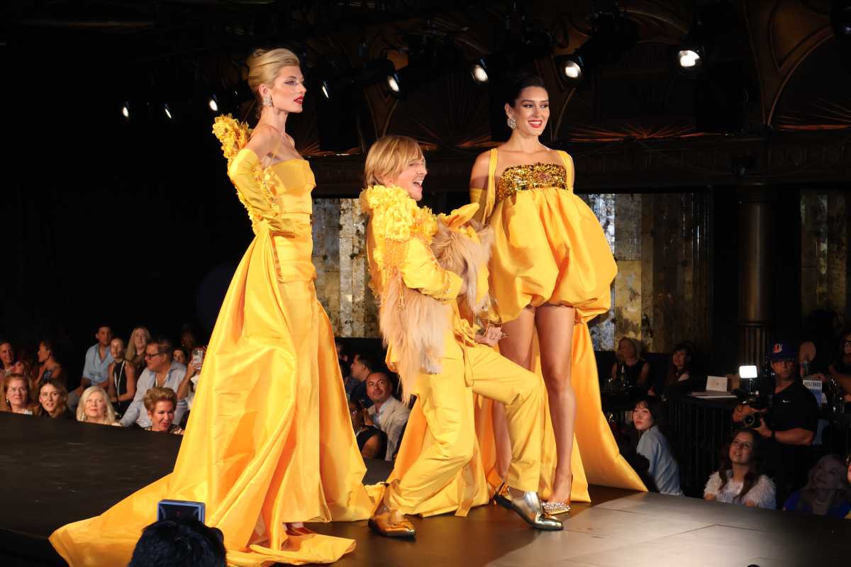 models with a dog walking for Designer Marc Bouwer 
