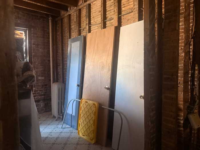 Diana Rodriguez's home was damaged in the fire, leaving her belongings covered in plastic as she lives with family.