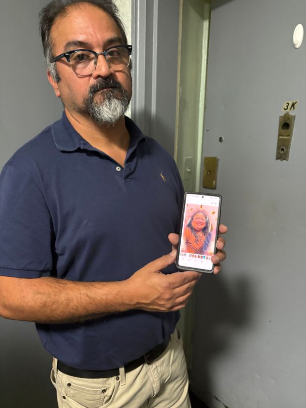 Pamela Cisneros' brother, Patrick Peralta, holds a photo of his sister a day after she was fatally shot by NYPD officers after refusing to drop two knives she was swinging as she approached them in Times Square Monday, Aug. 31, 2026, at Seventh Ave. and W. 43rd St. in Midtown Manhattan. (Roni Jacobson / New York Daily News)