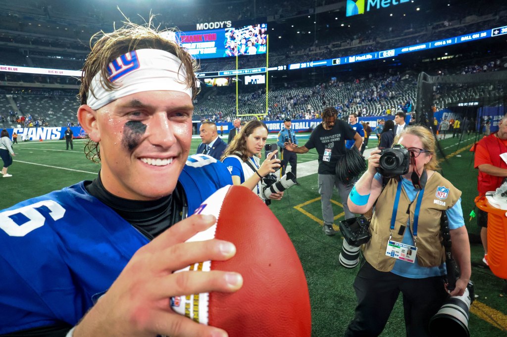 Jaxson Dart is all smiles as he walks off the field after the Giants' Week 1 win over the Cowboys at MetLife Stadium.
