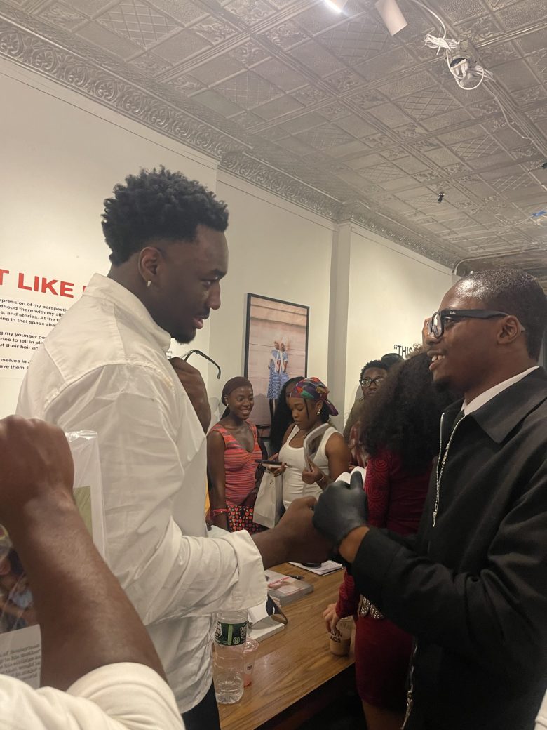 Souleyman Traore and a guest interacting at “Just Like My Own” magazine launch event.