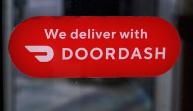 A DoorDash sign is posted on a door, Feb. 27, 2023, in Methuen, Mass.