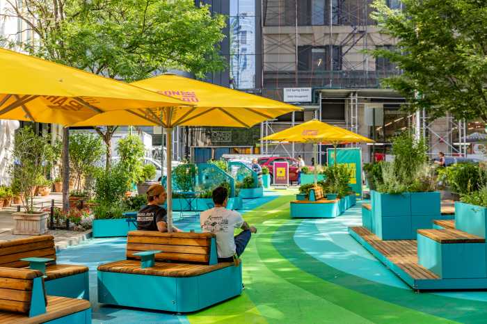 people sitting in an outdoor plaza