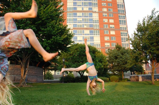 Much of Battery Park City was a dumping ground for World Trade Center debris. Photographed six years later, it was a place where girls turn cartwheels on the grass. (Susan Watts/New York Daily News)