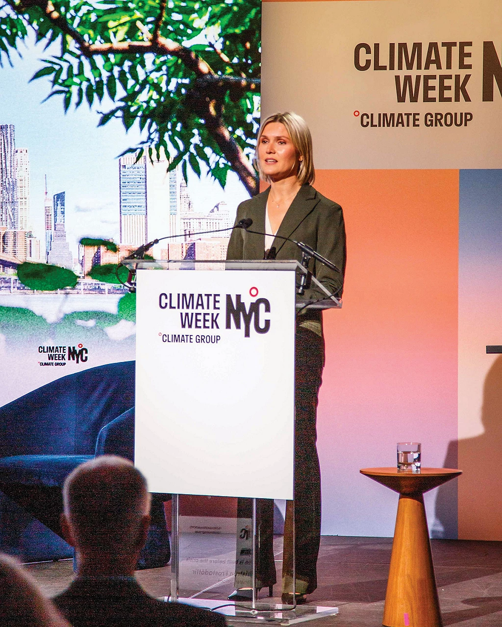 A person speaks at a lectern labeled “Climate Week NYC.”