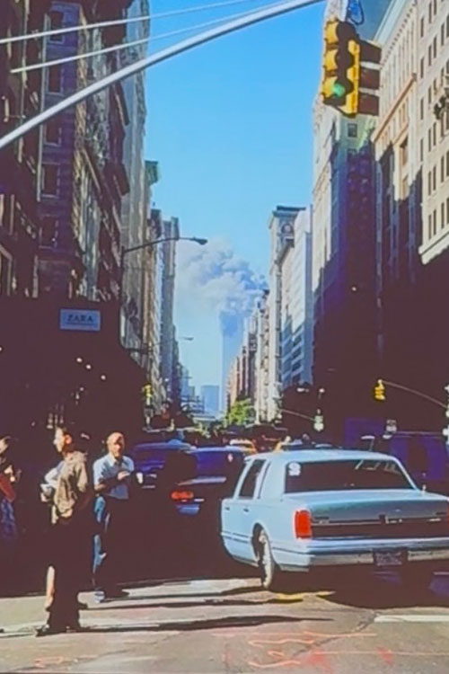 Photo by photojournalist Joe DiPetro captures the view of the burning Twin Towers from Fifth and 18th streets in front of his New York City office on the morning of Sept. 11, 2001. (Photo by Joe DiPetro) 