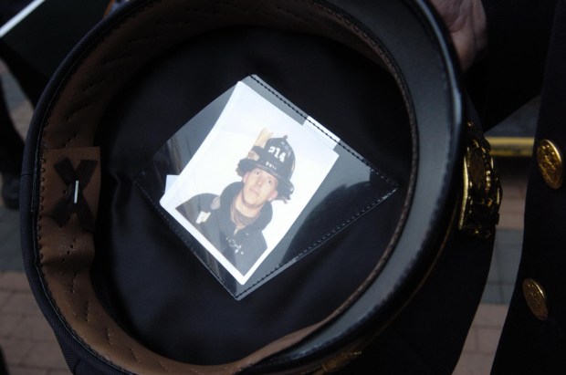 Chief of Brooklyn South Joseph Fox is pictured with a photo of his nephew, FDNY Firefighter Michael Roberts, inside his service cap in 2004. (Todd Maisel / New York Daily News)