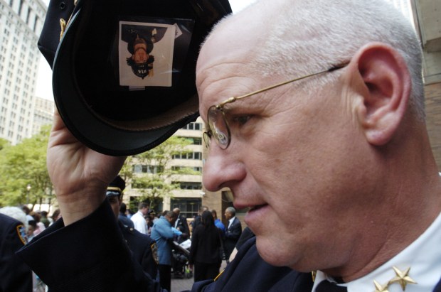 Chief of Brooklyn South Joseph Fox is pictured with a photo of his nephew, FDNY Firefighter Michael Roberts, inside his service cap in 2004. (Todd Maisel / New York Daily News)