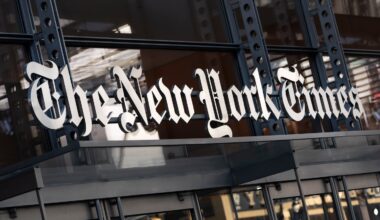A sign for The New York Times hangs above the entrance to its building in New York.