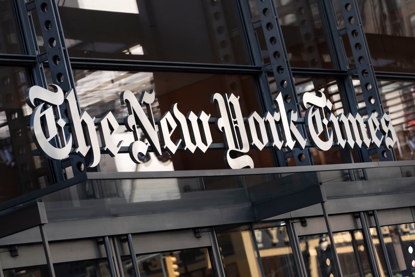A sign for The New York Times hangs above the entrance to its building in New York.