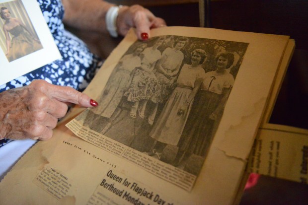 Charlene Johnson Brehm points to a new report from 1952 announcing contestants for Berthoud Flapjack Day Queen. She appears second from the left (Will Costello / Loveland Reporter Herald).