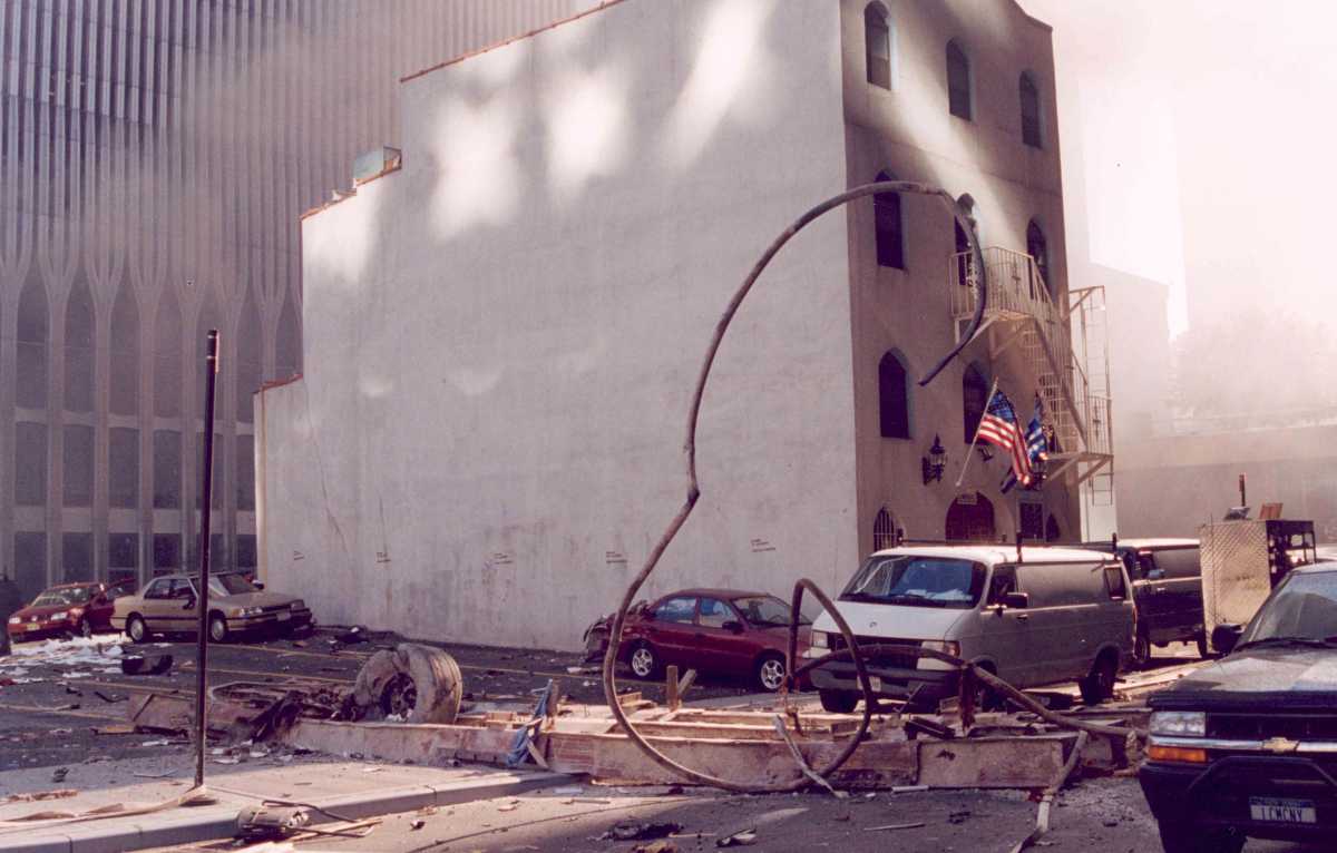 Airplane landing gear near Saint Nicholas Greek Orthodox Church with the World Trade Center tower in background during the Sept. 11, 2001, terrorist attacks. The church would be destroyed in the collapse of the Twin Towers.