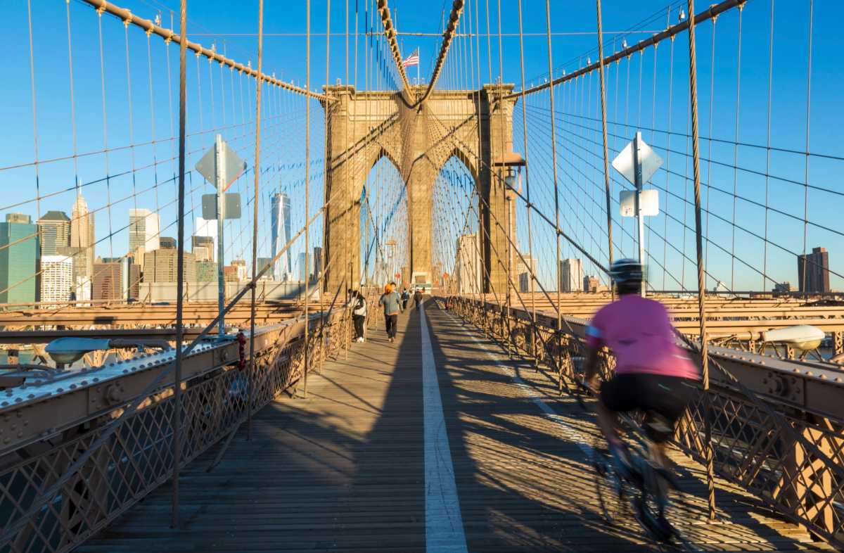Brooklyn Bridge walkway with bicyclist riding by