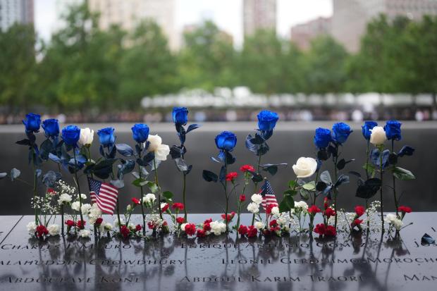 Flowers are seen at the memorial on the 25th anniversary of the September 11, 2001, terrorist attacks, Friday, Sept. 11, 2026, in New York. (AP Photo/Adam Gray)