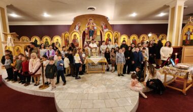 A commemorative photo of Fr. Vasileios Apostolidis with students and teachers during the Agiasmos blessing at Holy Trinity-St. Nicholas Church. Photo: TNH/Michael Kakias