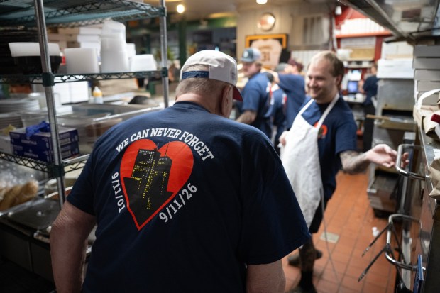 Owner Bill Ficke, a former Nuggets assistant coach and NBA scout, wears a shirt commemorating Sept. 11, 2001, along with his staff during the annual 
