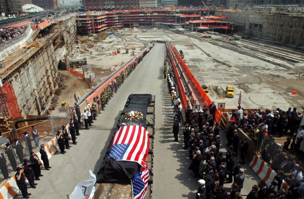 A flatbed truck carries away the last piece of steel salvaged from ground zero, the site where the World Trade Center once stood, during a ceremony marking the end of recovery and cleanup efforts in New York City on May 31, 2002.(Photo by Helen H. Richardson/The Denver Post)