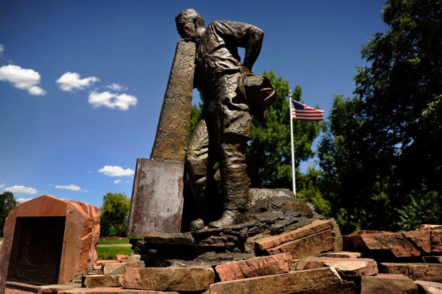A sculpture depicts an FDNY firefighter resting on part of a steel beam at the Broomfield 9/11 Memorial on Aug. 23, 2011, in Broomfield. The bottom part of the beam in the sculpture is steel from the remnants of the World Trade Center building in New York. (Photo by Joe Amon/The Denver Post)