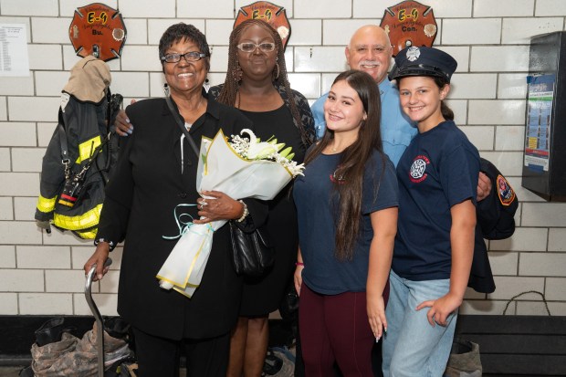 September 11th survivor FDNY firefighter Salvatore J .D' Agostino, middle, introduces poses for a photo with daughters Elaina Josephine D'Agostino, 14, left, and Alacia D'Agostino, right, to Thelma and Denise Johnson Wednesday, Sept. 1 2026 in Manhattan, New York. Josephine Harris and members of Engine 9 - Ladder 6 survived together in Stairwell B of the North Tower on Sept. 11, 2001. Firefighter D' Agostino named his daughter Elaina Josephine D'Agostino after Morris after she was born 9 lbs. 11 Oz. (Barry Williams/ New York Daily News)