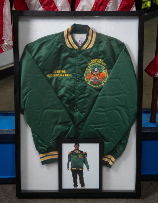 The jacket that was presented to Josephine Harris by members of Engine 9 - Ladder 6 who survived together in Stairwell B of the North Tower on Sept. 11, 2001 is pictured in a frame in the Engine 9- Ladder 6 firehouse Sept. 1, 2026 in Manhattan, New York. Family members of Harris returned the jacket firefighters to be permanently on display in the Chinatown firehouse. (Barry Williams/ New York Daily News)