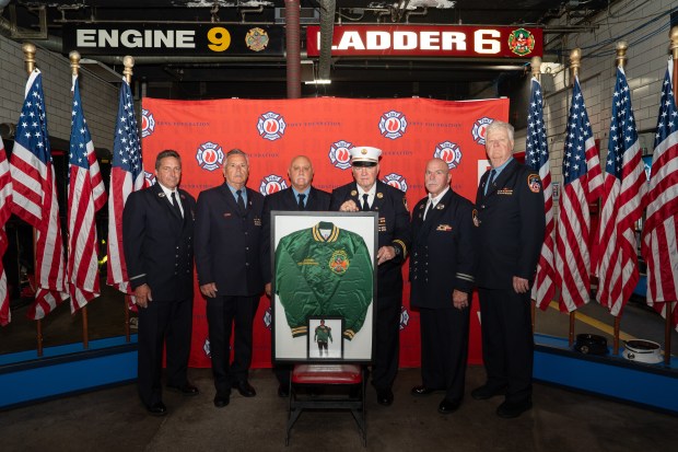 FDNY firefighter and survivors of "Miracle of Stairwell B" (L-R) Lt Matt Komorowski, FF Tom Falco, FF Sal D'Agostino, Chief Jay Jonas, Capt Billy Butler, FF Mike Meldrum pose for a photo after a ceremony returning the jacket that was presented to Josephine Harris by members of Engine 9 - Ladder 6 who survived together in Stairwell B of the North Tower on Sept. 11, 2001 back to Engine 9- Ladder 6 Wednesday, Sept. 1, 2026 in Manhattan, New York. Family members of Morris returned the jacket firefighters to be permanently on display in the Chinatown firehouse. (Barry Williams/ New York Daily News)