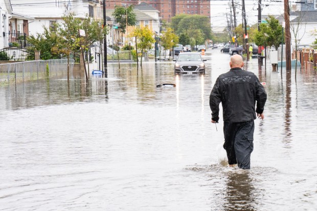 (A man walks through flood waters on Beach 71st Street) A powerful Nor'easter brought heavy, wind driven downpours to New York City, causing widespread flooding and bringing down trees on Saturday September 26, 2026. 0739. (Theodore Parisienne / New York Daily News)