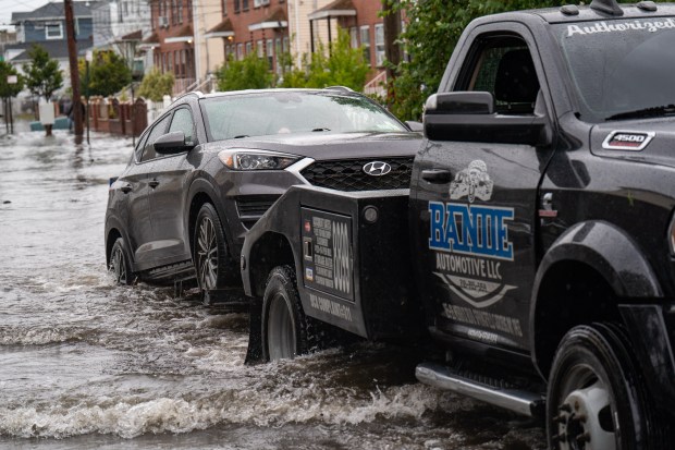 (This tow truck pulls Suki out of the flood waters on Beach 71st Street) A powerful Nor'easter brought heavy, wind driven downpours to New York City, causing widespread flooding and bringing down trees on Saturday September 26, 2026. 0739. (Theodore Parisienne / New York Daily News)