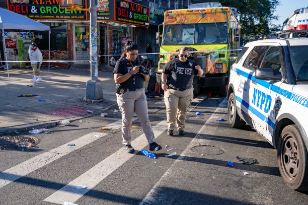 Police investigate after three people were stabbed on Utica Ave. and Carroll St. in Crown Heights on Monday morning.