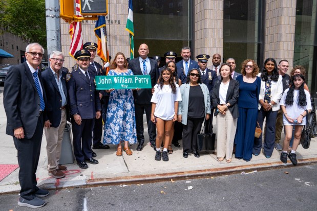 Family of Officer John William Perry join members of the NYPD at a street renaming ceremony in his honor on Madison Avenue and East 101st St. in Manhattan on Saturday. 
