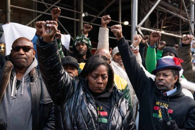 Protestors raise their hands during a rally outside Gov. Kathy Hochul's midtown office calling for justice in death of Robert Brooks at the hands of NYS corrections officers Monday, Dec. 30, 2024 in Manhattan, New York. (Barry Williams/ New York Daily News)